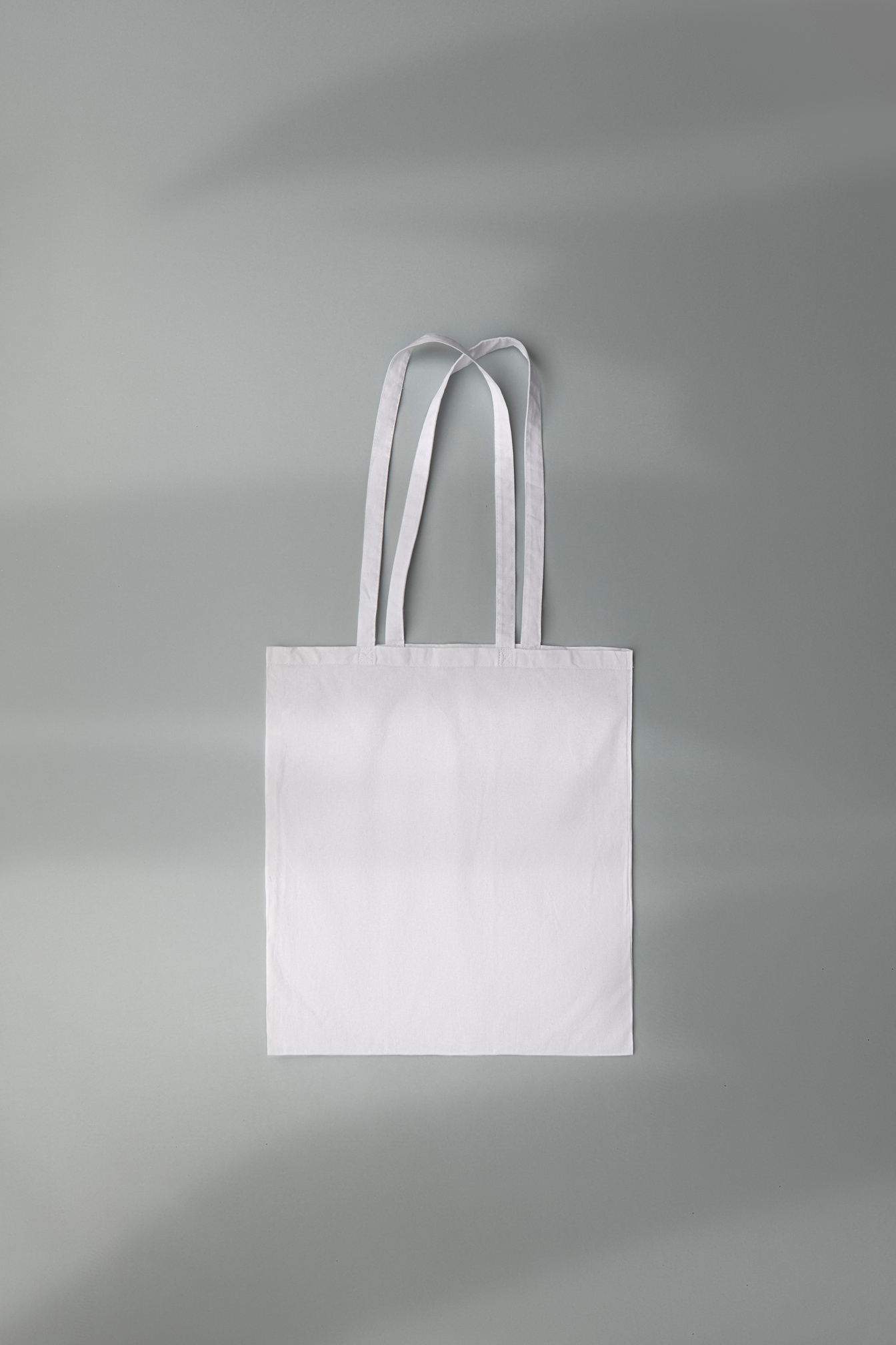 White Tote Bag on Grey Background